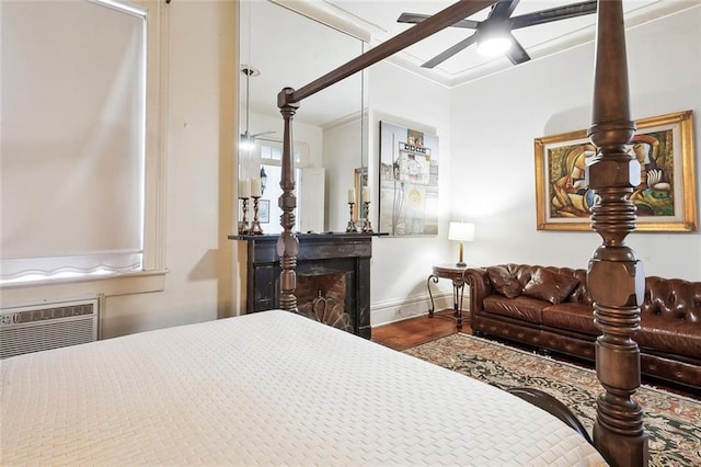 bedroom with ceiling fan, wood-type flooring, and an AC wall unit