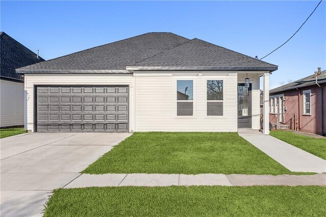 view of front facade with a garage and a front lawn