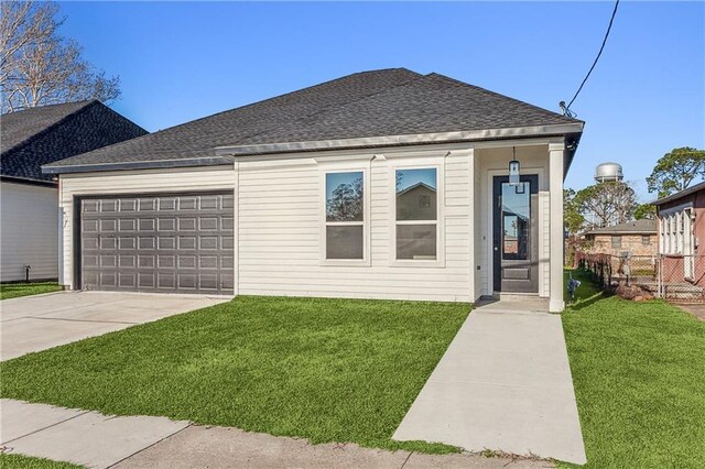 view of front of property featuring a garage and a front yard