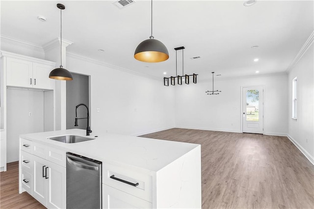 718 W Dr, Westwego, LA 70094 - kitchen featuring stainless steel dishwasher, ornamental molding, light wood-type flooring, a kitchen island with sink, and hanging light fixtures
