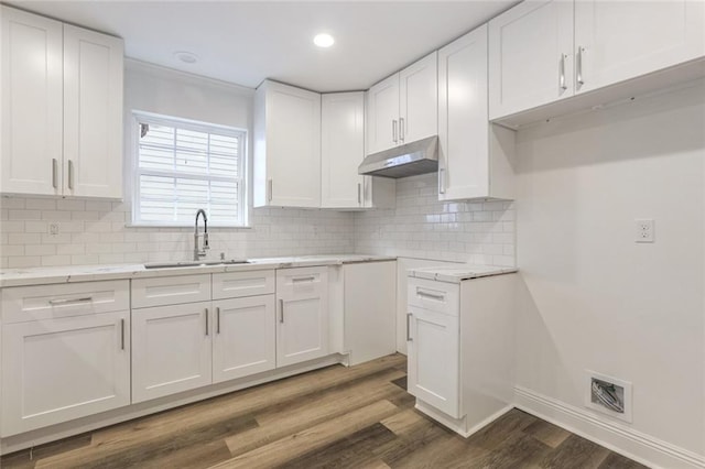 kitchen with sink, white cabinets, dark hardwood / wood-style floors, and decorative backsplash