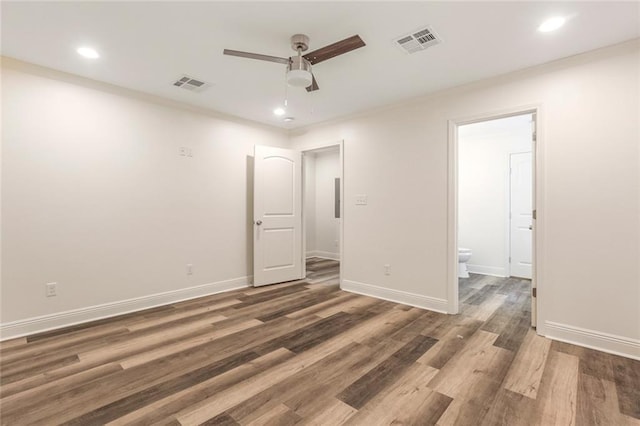 empty room with ceiling fan and dark hardwood / wood-style flooring