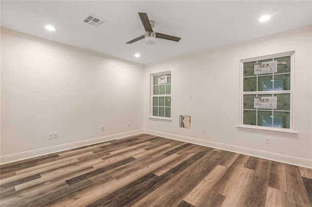 spare room featuring dark wood-type flooring and ceiling fan