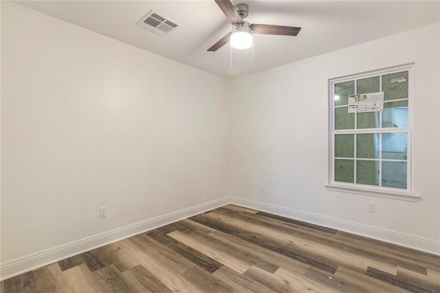 empty room featuring hardwood / wood-style flooring and ceiling fan