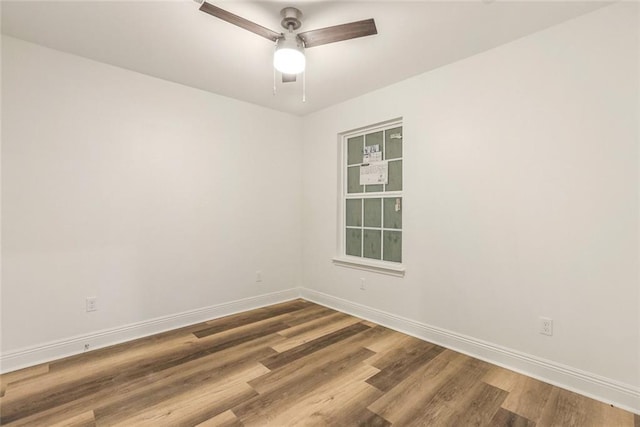 empty room with hardwood / wood-style flooring and ceiling fan