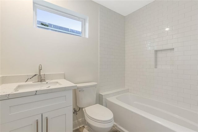 full bathroom with vanity, tiled shower / bath, and toilet