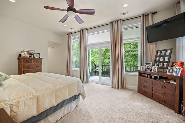 bedroom with access to exterior, ceiling fan, and light colored carpet