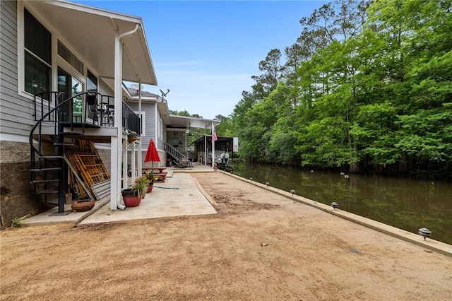 31753 River Pines Dr, Springfield, LA 70462 - exterior space with stairs and a water view