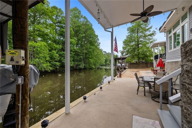 31753 River Pines Dr, Springfield, LA 70462 - view of patio / terrace featuring fence, a ceiling fan, and a water view