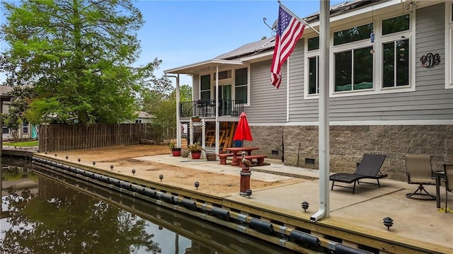 31753 River Pines Dr, Springfield, LA 70462 - view of play area with fence, a water view, and a patio area