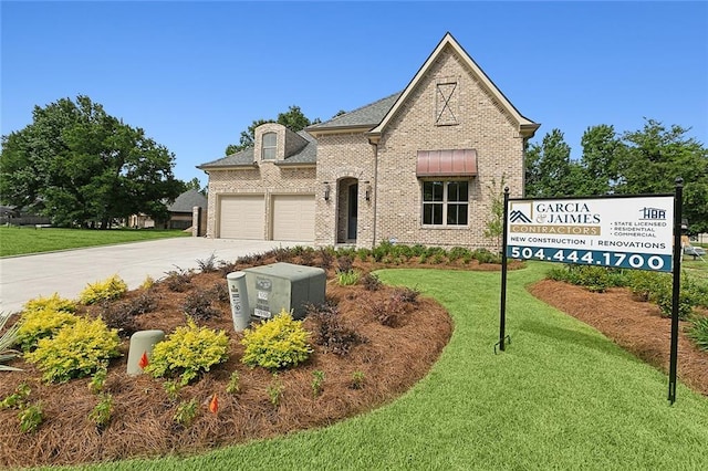 view of front of home with a garage and a front yard