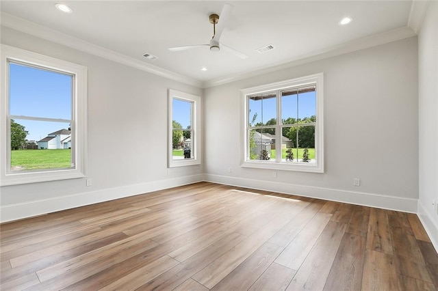 empty room featuring ceiling fan, wood-type flooring, and ornamental molding