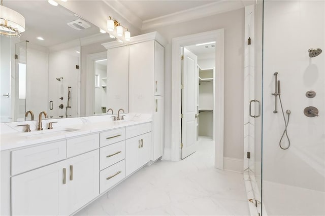 bathroom with a shower with door, vanity, and ornamental molding