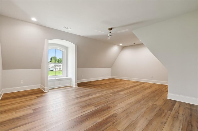 additional living space featuring light hardwood / wood-style floors, ceiling fan, and lofted ceiling