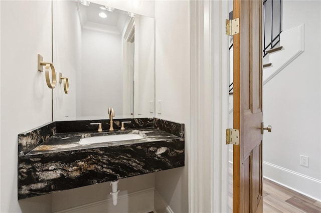 bathroom with hardwood / wood-style floors and sink