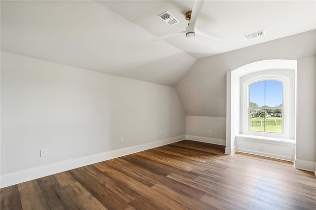 additional living space featuring hardwood / wood-style flooring, vaulted ceiling, and ceiling fan