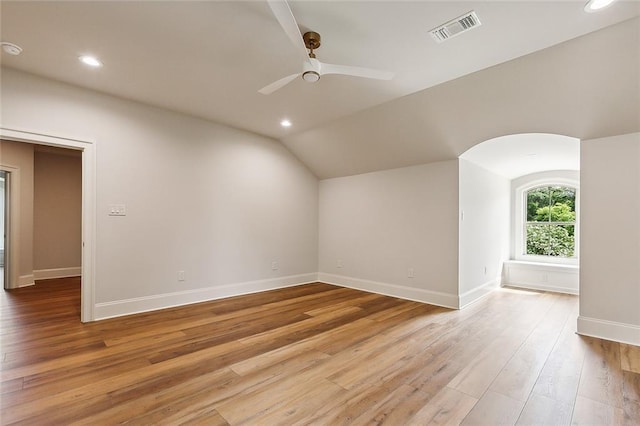 additional living space with ceiling fan, light hardwood / wood-style flooring, and vaulted ceiling