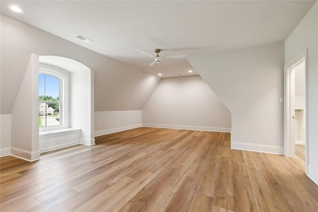 bonus room with light wood-type flooring, vaulted ceiling, and ceiling fan