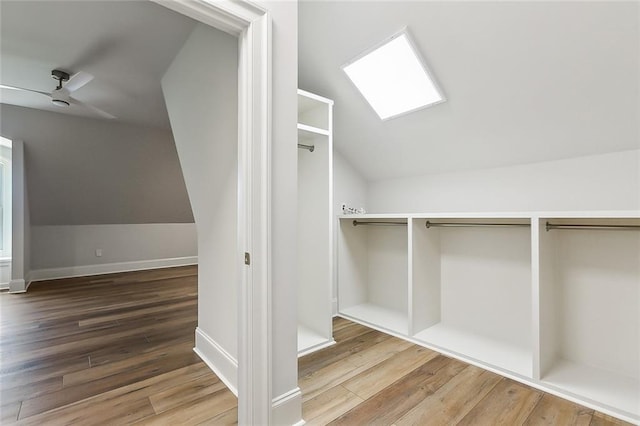 spacious closet with wood-type flooring, ceiling fan, and lofted ceiling