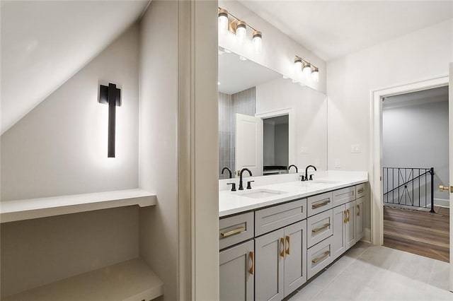 bathroom featuring vanity, tile patterned floors, and lofted ceiling