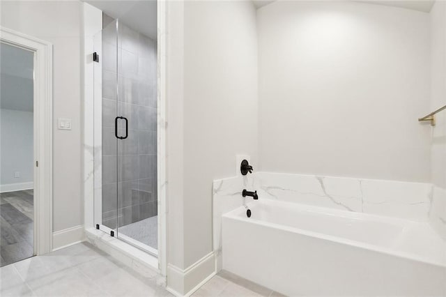 bathroom featuring shower with separate bathtub and tile patterned floors