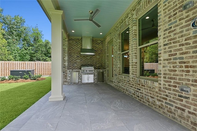 view of patio / terrace featuring grilling area, ceiling fan, and an outdoor kitchen