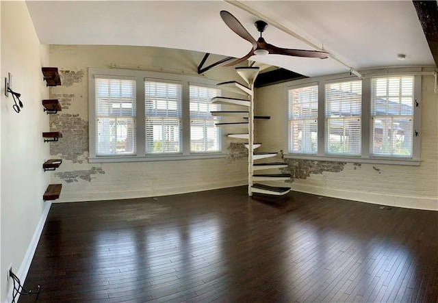 interior space featuring beam ceiling, dark wood-type flooring, and ceiling fan