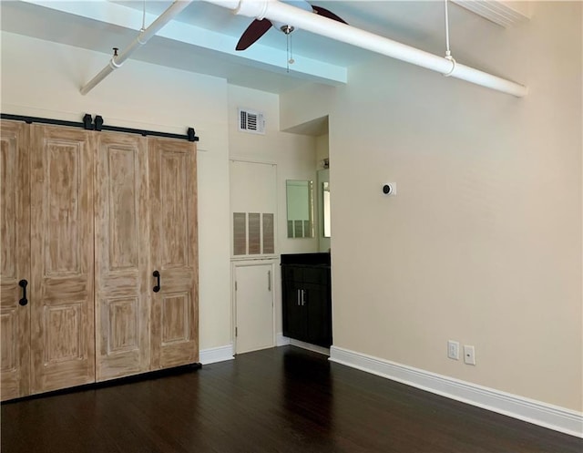 unfurnished bedroom featuring dark hardwood / wood-style floors and ceiling fan