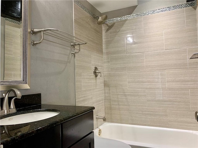 bathroom featuring vanity and tiled shower / bath combo