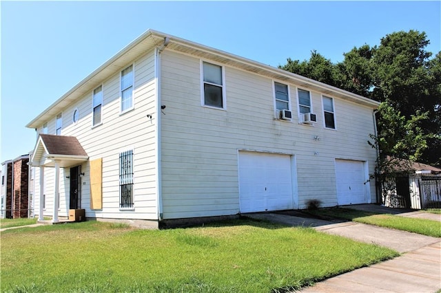 view of front facade with cooling unit, a front yard, and a garage