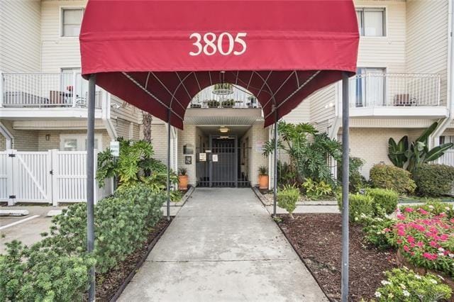 view of exterior entry featuring a balcony