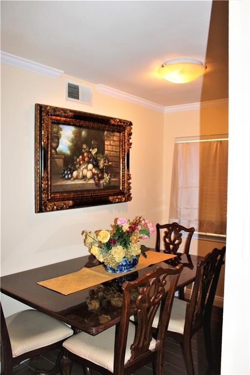 dining space featuring crown molding