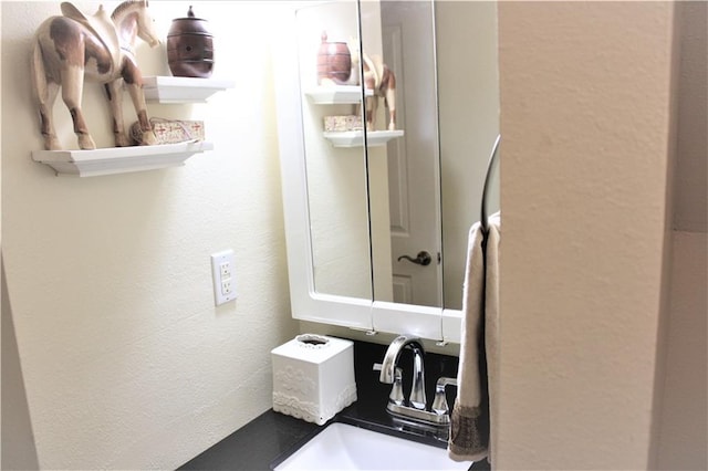 3805 Houma Blvd Unit C201, Metairie, LA 70006 - bathroom featuring a textured wall and a sink