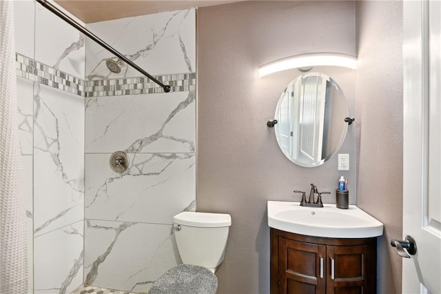 bathroom with vanity, walk in shower, and toilet