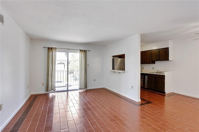 empty room featuring ceiling fan and sink