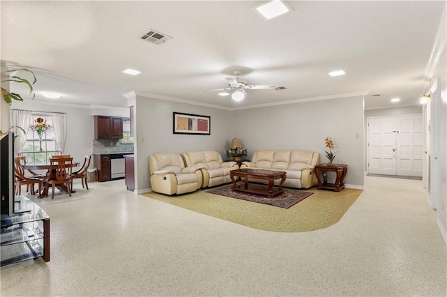 living room with ornamental molding, a ceiling fan, visible vents, and baseboards