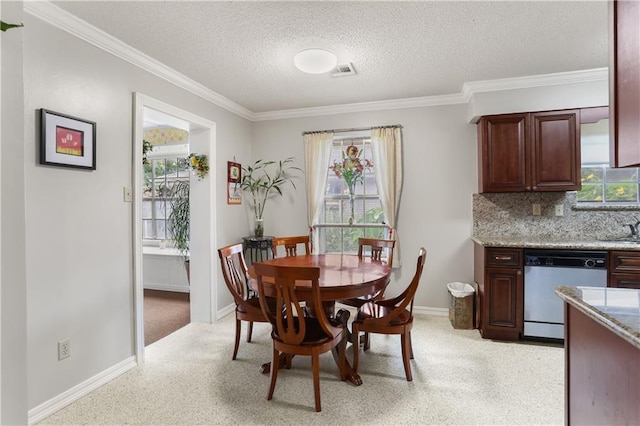 dining area with crown molding, visible vents, a textured ceiling, and light colored carpet