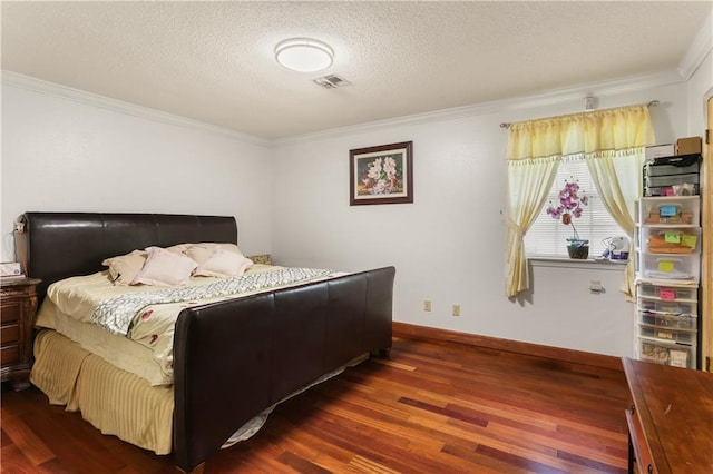 bedroom with crown molding, visible vents, dark wood finished floors, and a textured ceiling