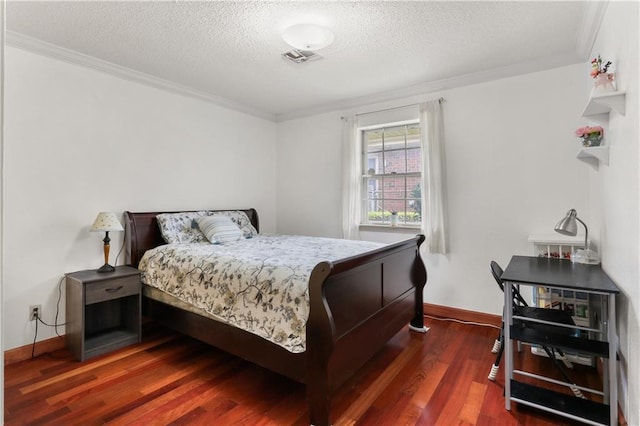 bedroom with baseboards, ornamental molding, dark wood finished floors, and a textured ceiling