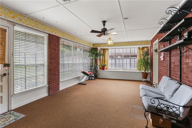 unfurnished sunroom with a ceiling fan