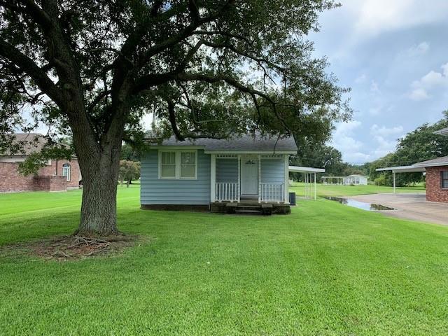 back of house with a yard and a carport