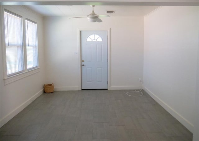 foyer entrance featuring ceiling fan