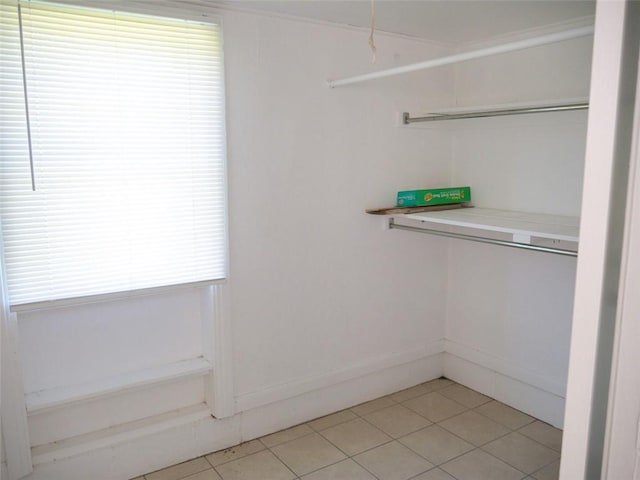 spacious closet with light tile patterned floors