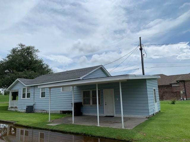 rear view of house with a yard