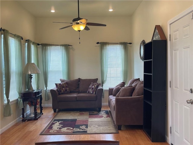 living room with ceiling fan and wood-type flooring