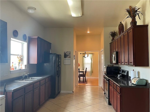 kitchen with sink, light tile patterned floors, and stainless steel electric range