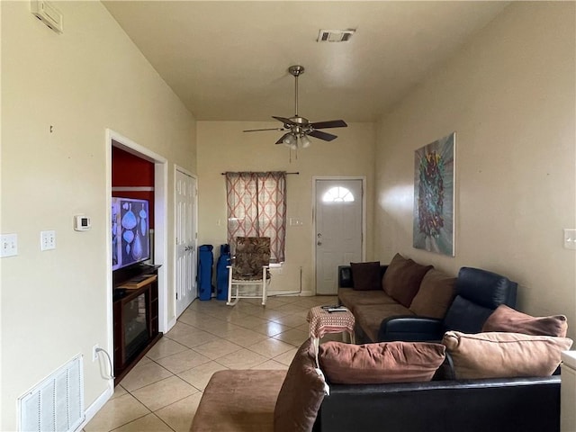 living room featuring light tile patterned floors and ceiling fan