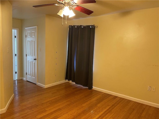 empty room featuring hardwood / wood-style floors and ceiling fan