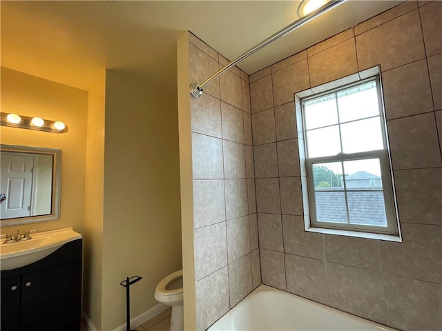 full bathroom with vanity, tiled shower / bath, and toilet