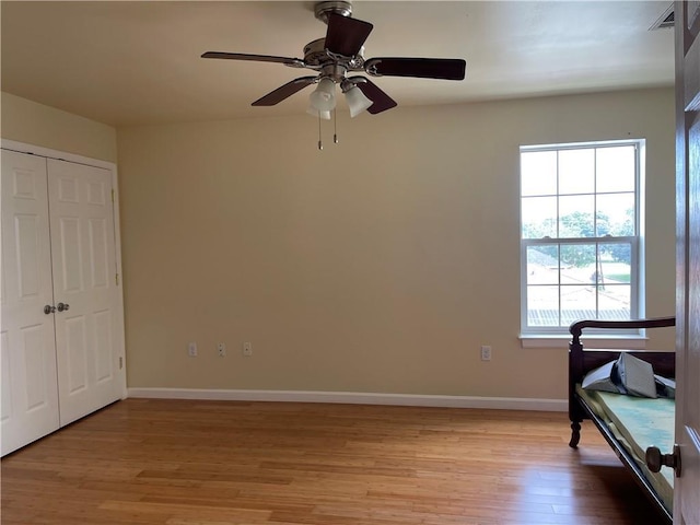 bedroom with ceiling fan, a closet, and light wood-type flooring